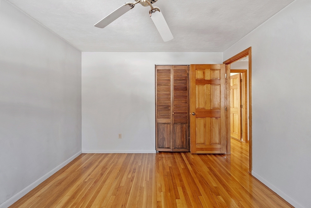 187 Mill Road Chelmsford, MA 01824 - Photo 11 of 32 an empty room with wooden floor and door