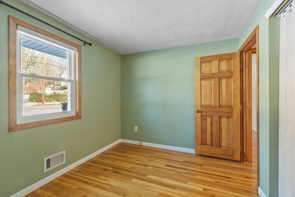 187 Mill Road Chelmsford, MA 01824 - Photo 12 of 32 a view of empty room with wooden floor and fan
