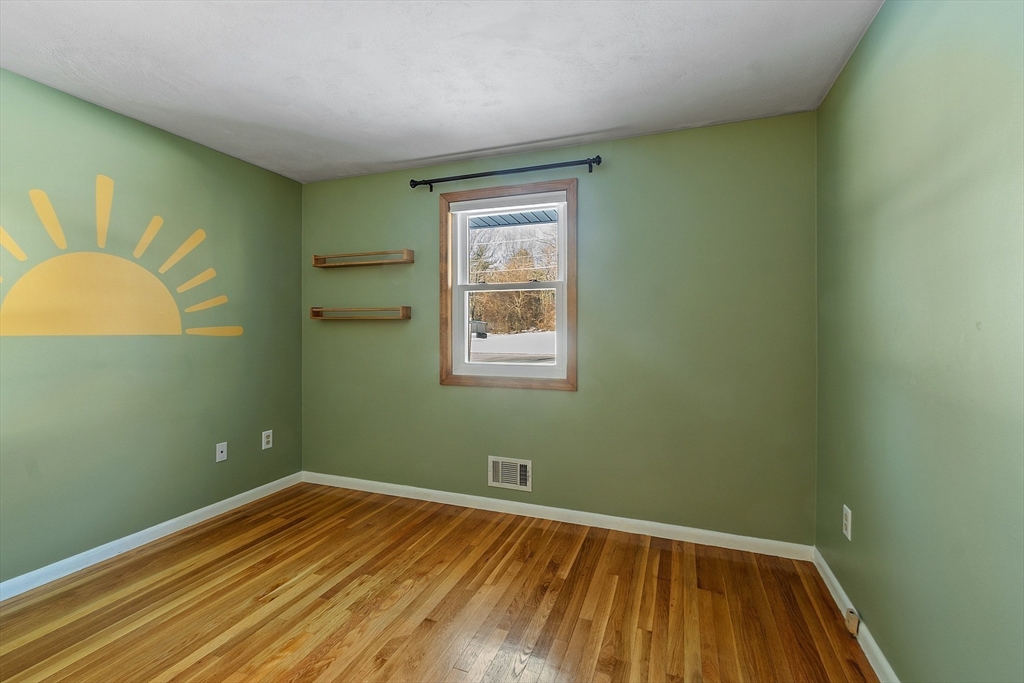 187 Mill Road Chelmsford, MA 01824 - Photo 14 of 32 a view of a room with wooden floor and windows