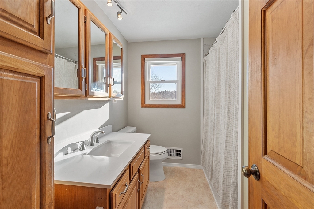 187 Mill Road Chelmsford, MA 01824 - Photo 17 of 32 a bathroom with a sink toilet and mirror