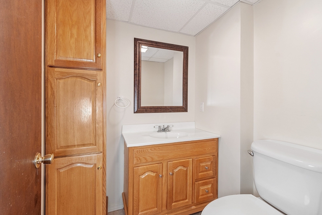 187 Mill Road Chelmsford, MA 01824 - Photo 20 of 32 a bathroom with a sink a toilet and mirror
