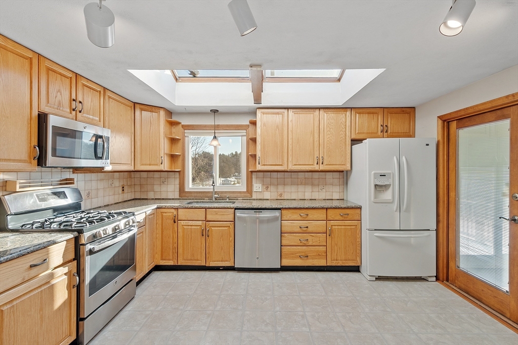 187 Mill Road Chelmsford, MA 01824 - Photo 2 of 32 a kitchen with granite countertop a refrigerator stove top oven and sink