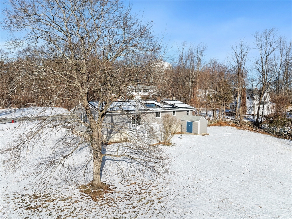 187 Mill Road Chelmsford, MA 01824 - Photo 32 of 32 a view of a white house with a snow