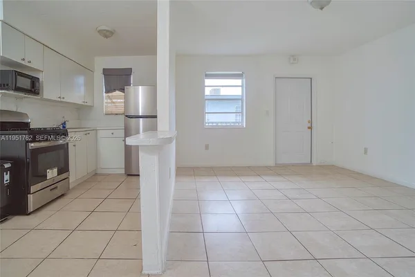 a kitchen with a stove a sink and a refrigerator