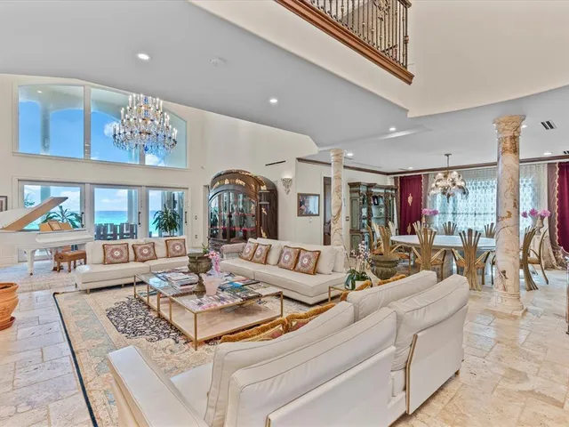 a living room with fireplace furniture and a large window