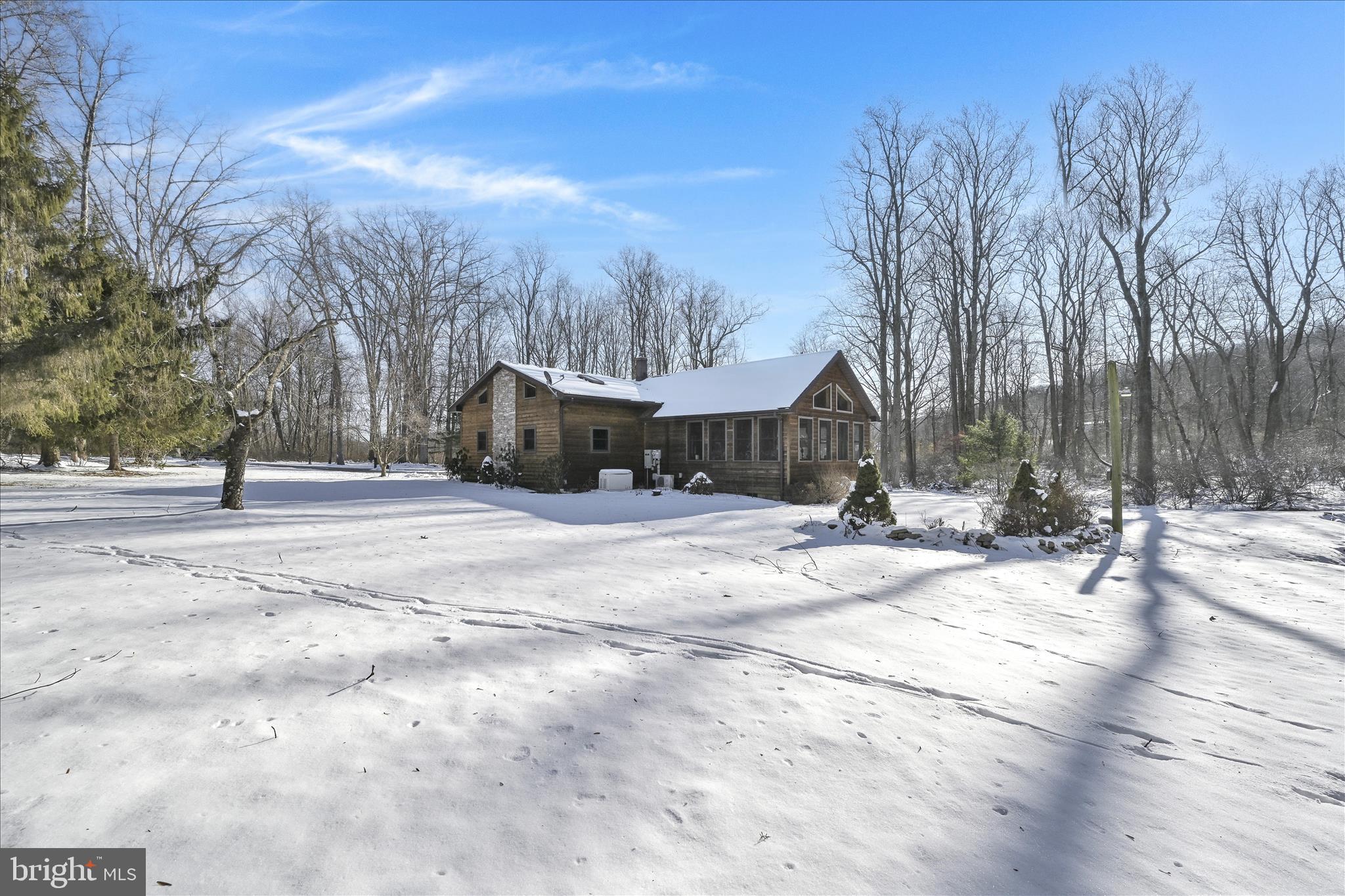 a view of a house with snow on the road