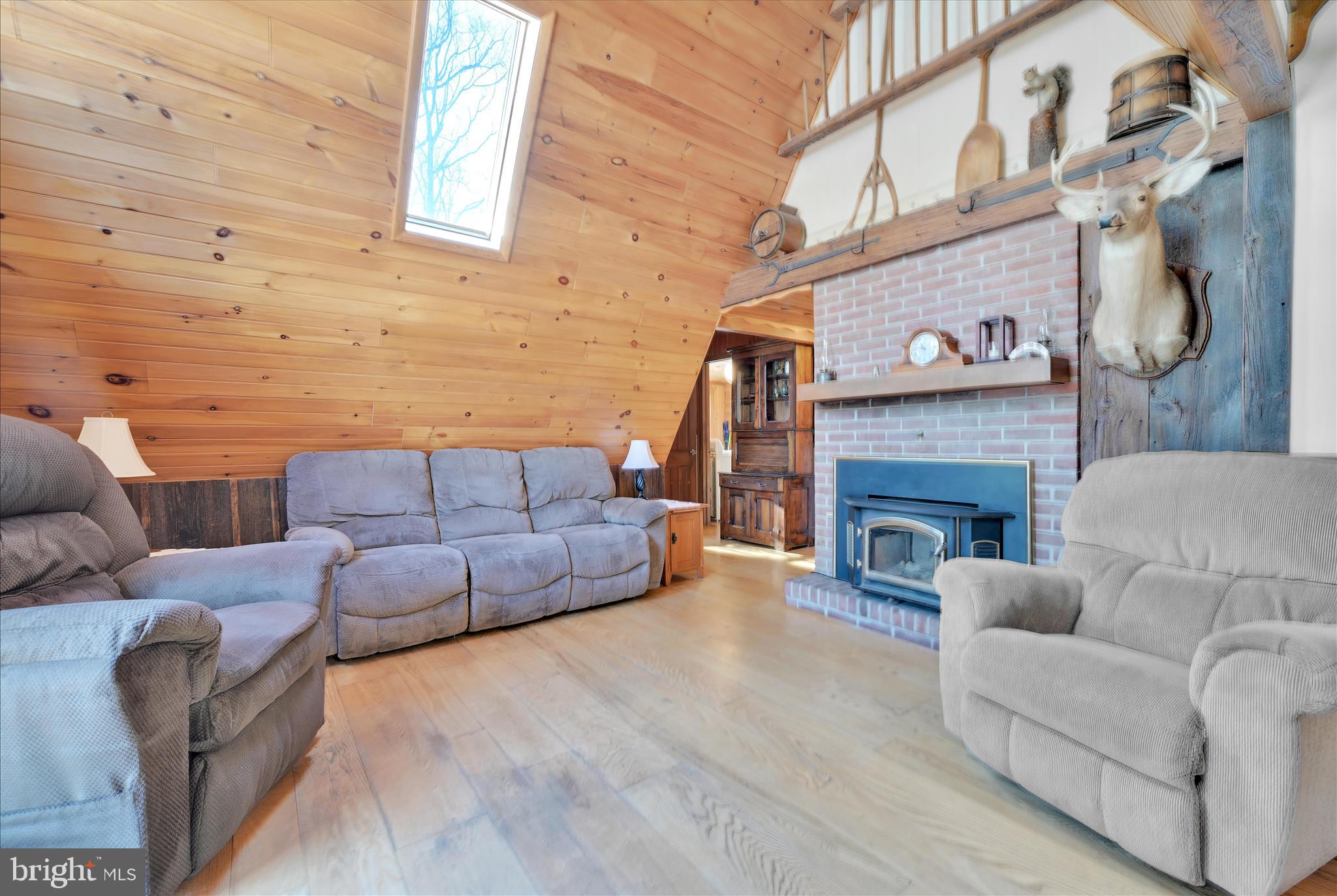 166 Camp Strauss Road Fredericksburg, PA 17026 - Photo 13 of 40 a living room with furniture and a fireplace