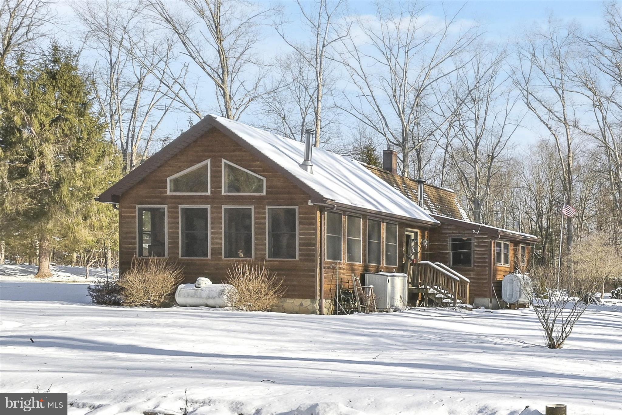 166 Camp Strauss Road Fredericksburg, PA 17026 - Photo 34 of 40 a front view of a house with a garden and trees