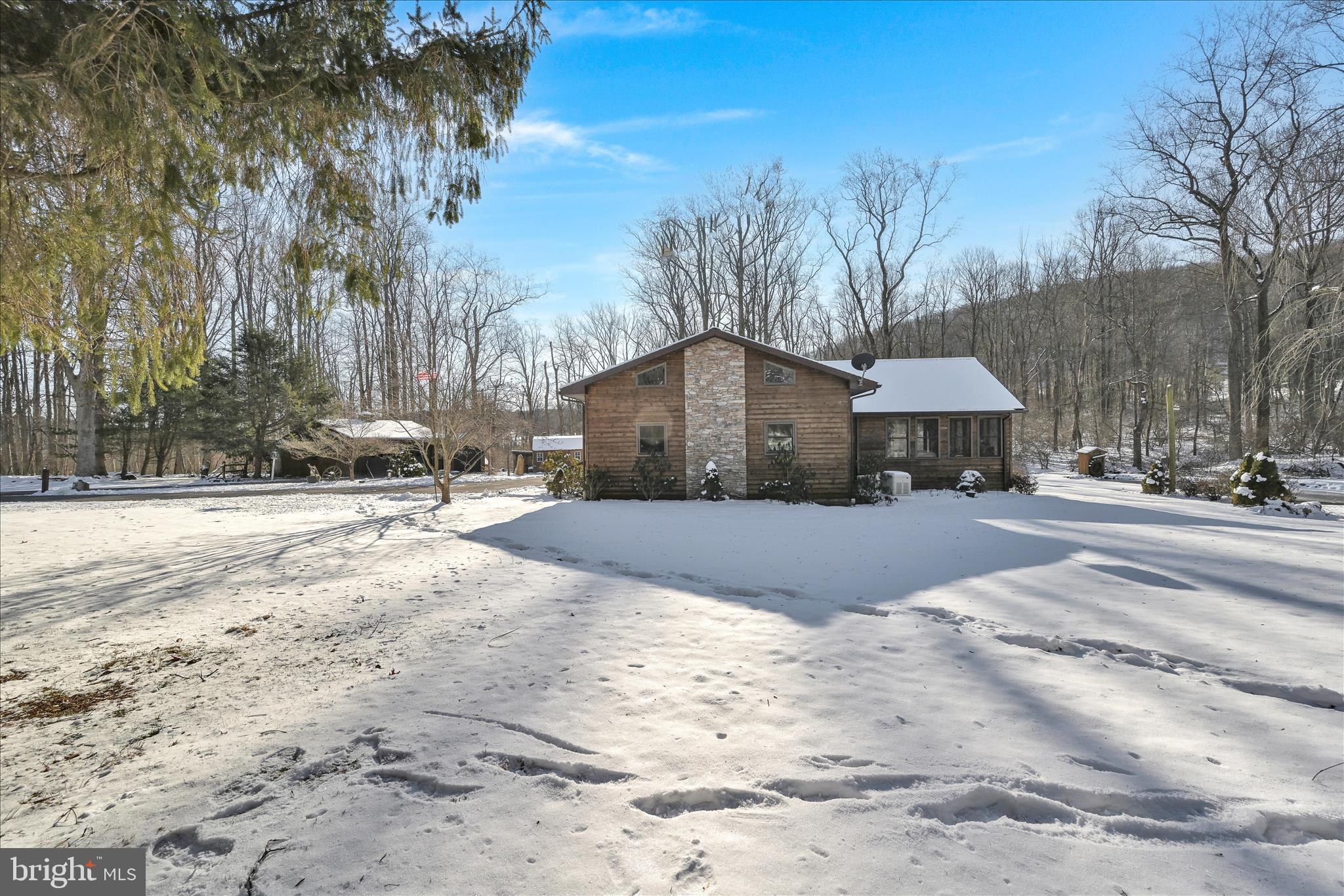 166 Camp Strauss Road Fredericksburg, PA 17026 - Photo 36 of 40 a front view of a house with a yard covered with snow and trees