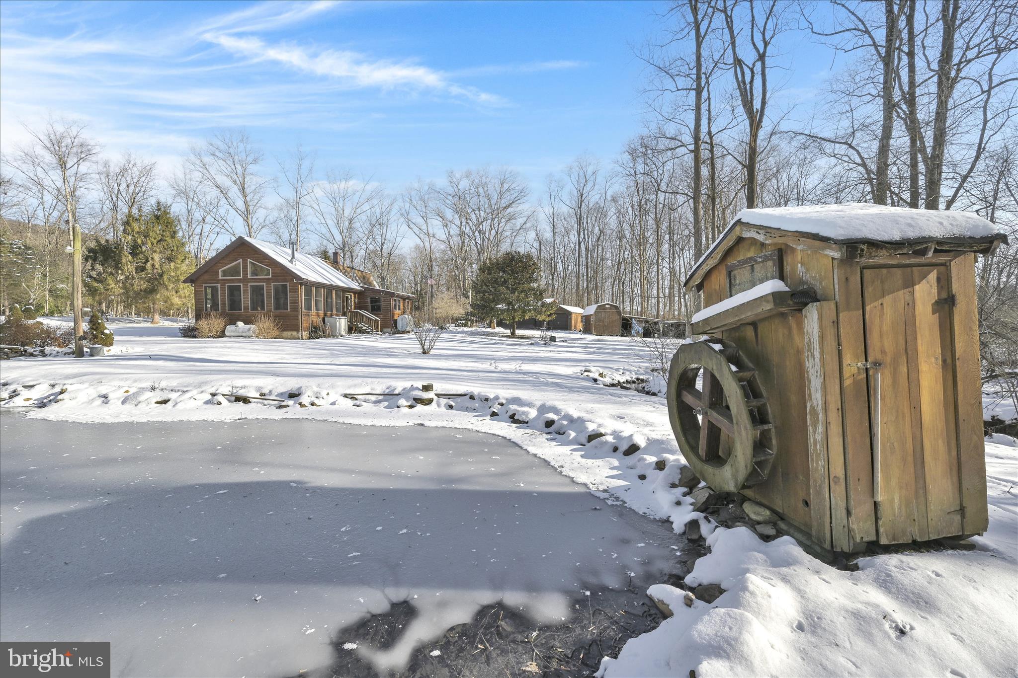 166 Camp Strauss Road Fredericksburg, PA 17026 - Photo 4 of 40 a view of a wooden house with a snow on the road