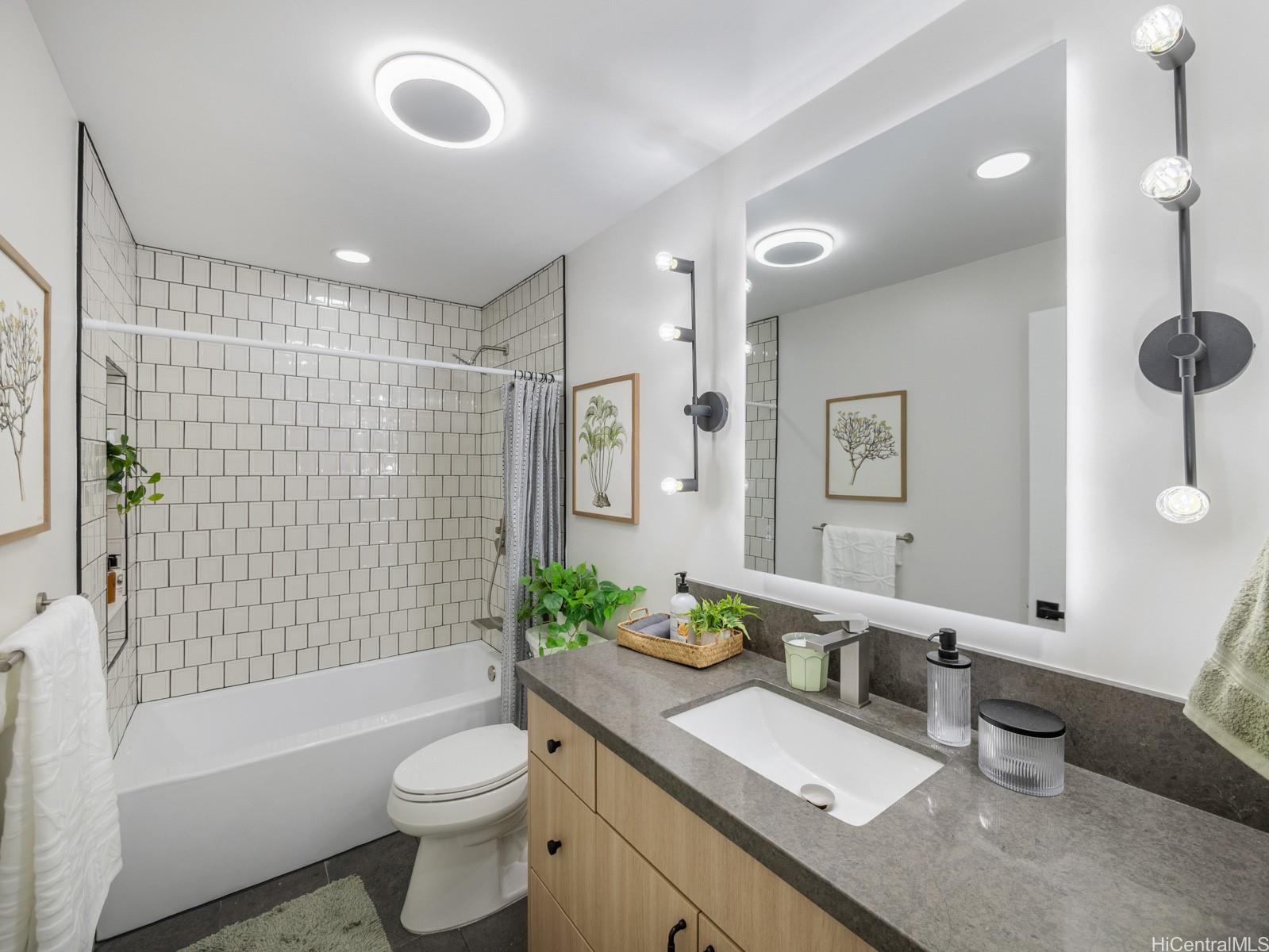 1843 A 10th Avenue Honolulu, HI 96816 - Photo 15 of 22 a bathroom with a granite countertop sink toilet mirror and bathtub