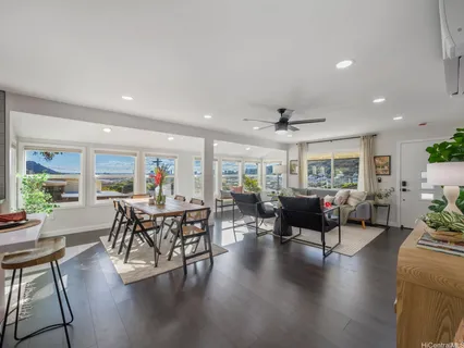 a living room with lots of furniture and wooden floor