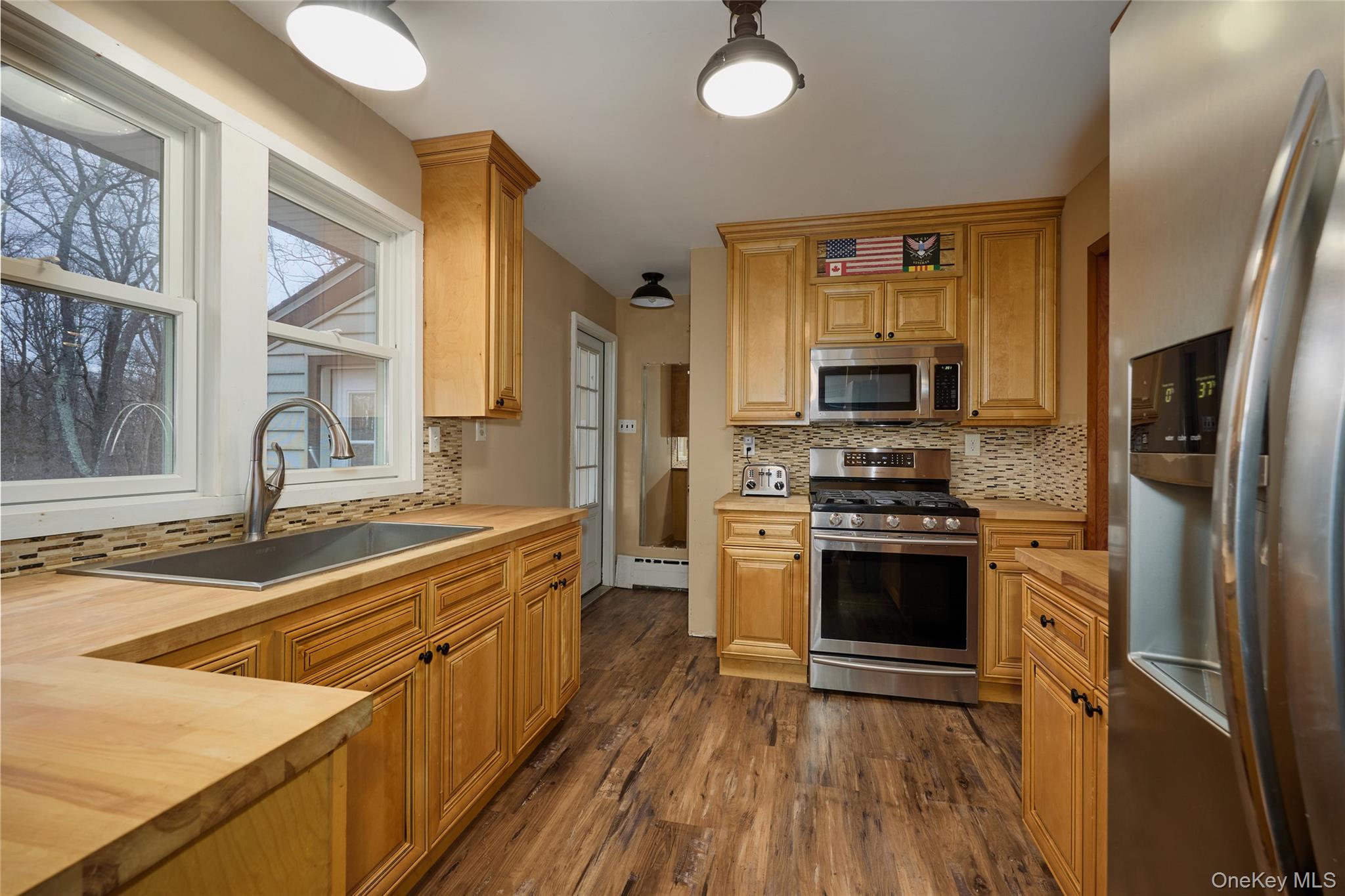 351 Freedom Road Pleasant Valley, NY 12569 - Photo 14 of 31 Luxury vinyl floor, tile backsplash, newer appliances.