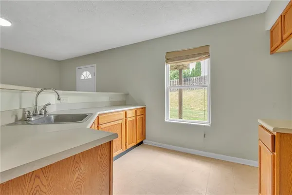 a view of a kitchen with a sink dishwasher and a microwave oven