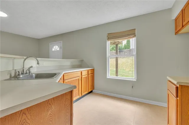 a view of a kitchen with a sink dishwasher and a microwave oven