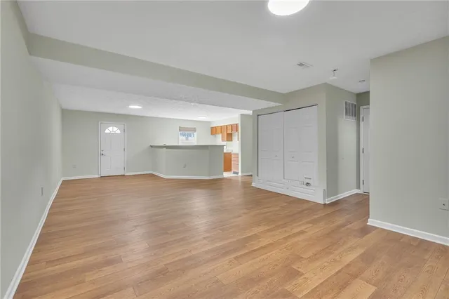 a view of empty room with wooden floor