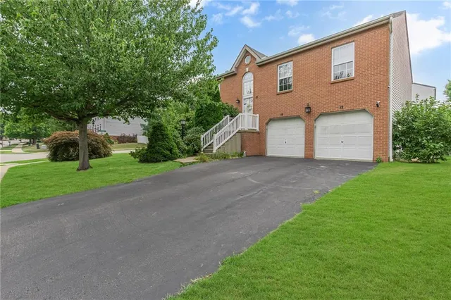 a front view of house with yard and green space