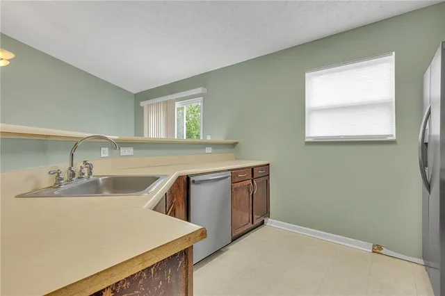 a kitchen with a sink cabinets and window