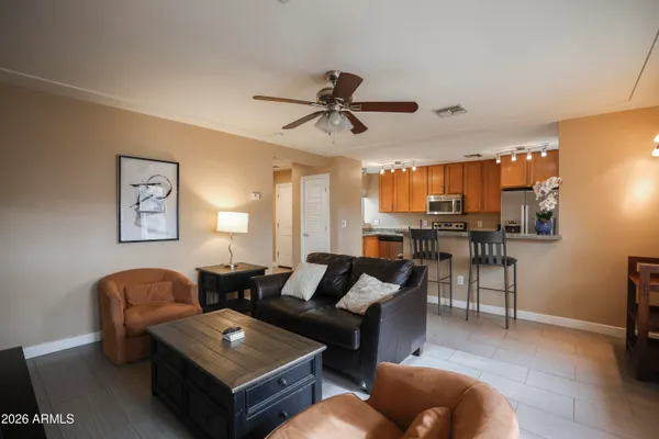 a living room with furniture a rug and a chandelier