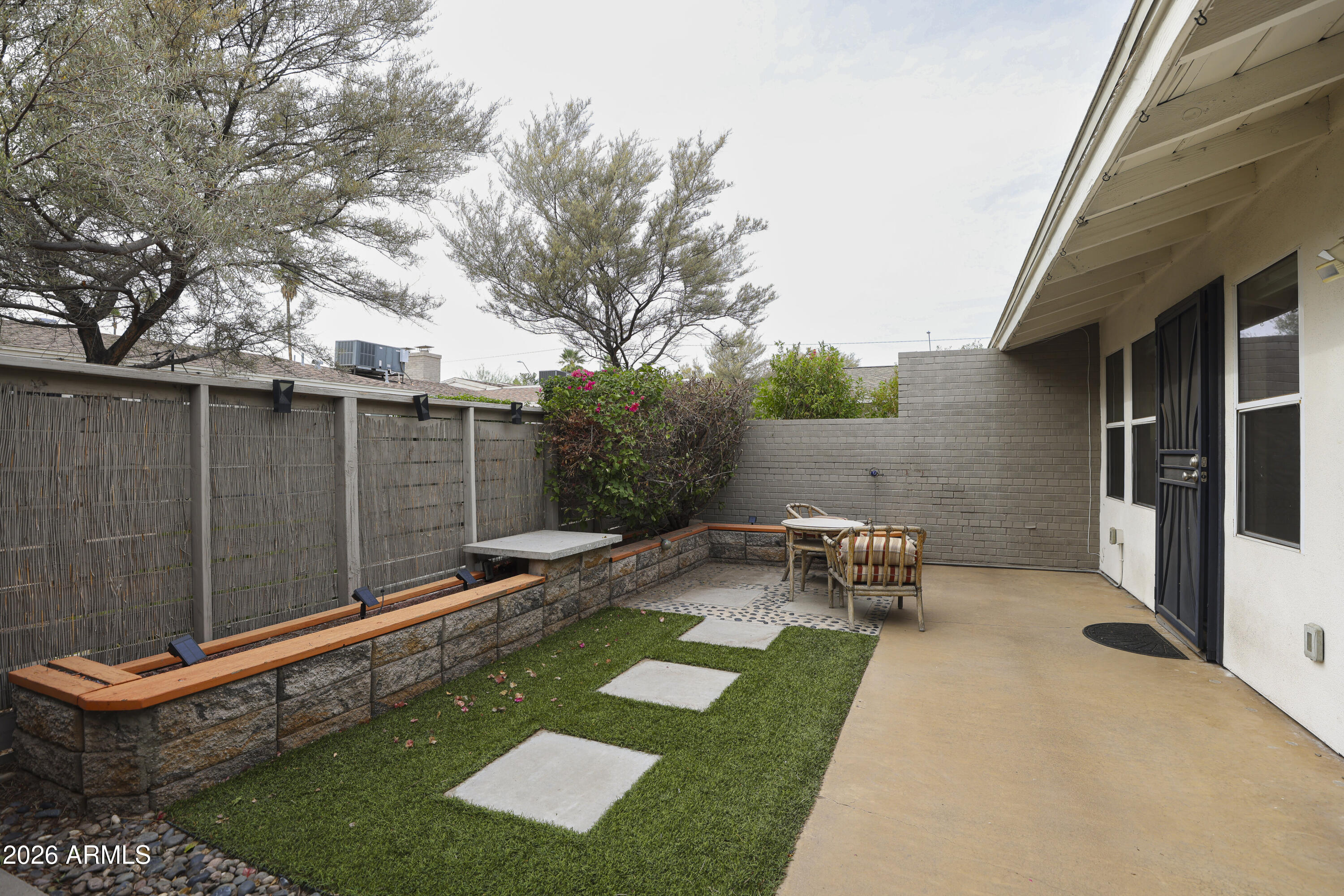 925 West McDowell Road, Unit 108 Phoenix, AZ 85007 - Photo 14 of 22 a backyard of a house with table and chairs