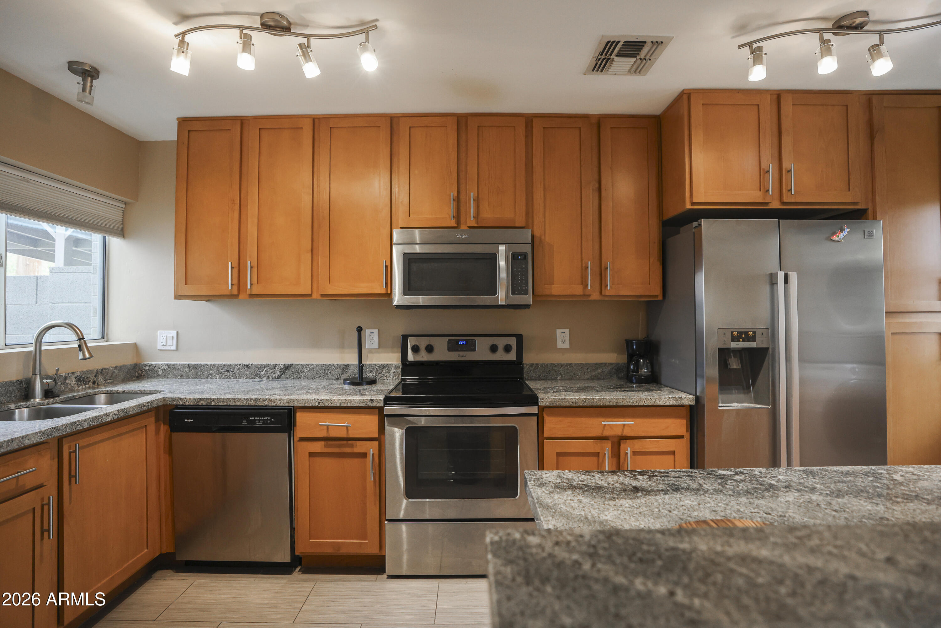 925 West McDowell Road, Unit 108 Phoenix, AZ 85007 - Photo 2 of 22 a kitchen with stainless steel appliances granite countertop a stove a refrigerator and a sink