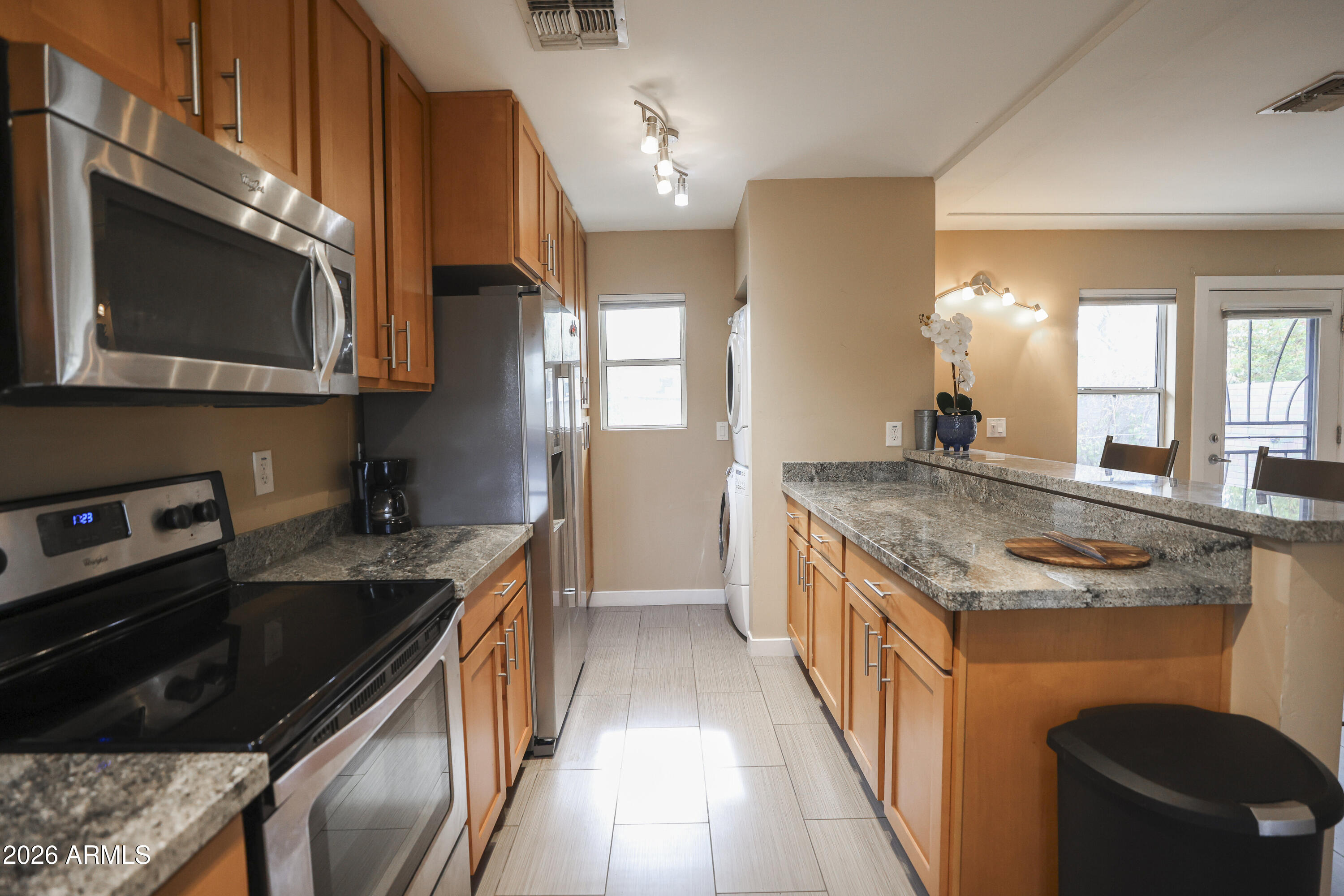 925 West McDowell Road, Unit 108 Phoenix, AZ 85007 - Photo 4 of 22 a kitchen with stainless steel appliances granite countertop a stove a sink and a microwave