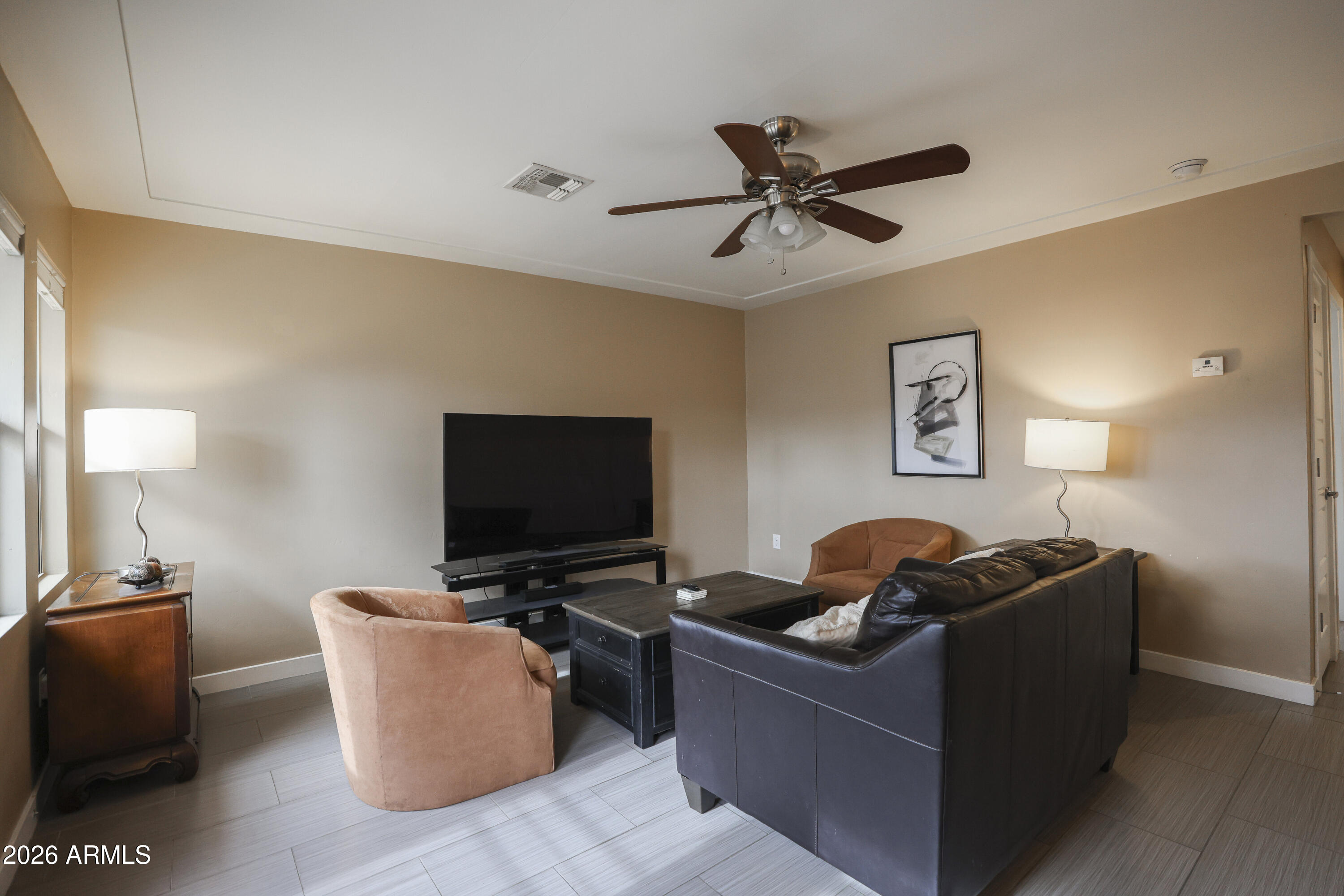 925 West McDowell Road, Unit 108 Phoenix, AZ 85007 - Photo 8 of 22 a living room with furniture and a flat screen tv