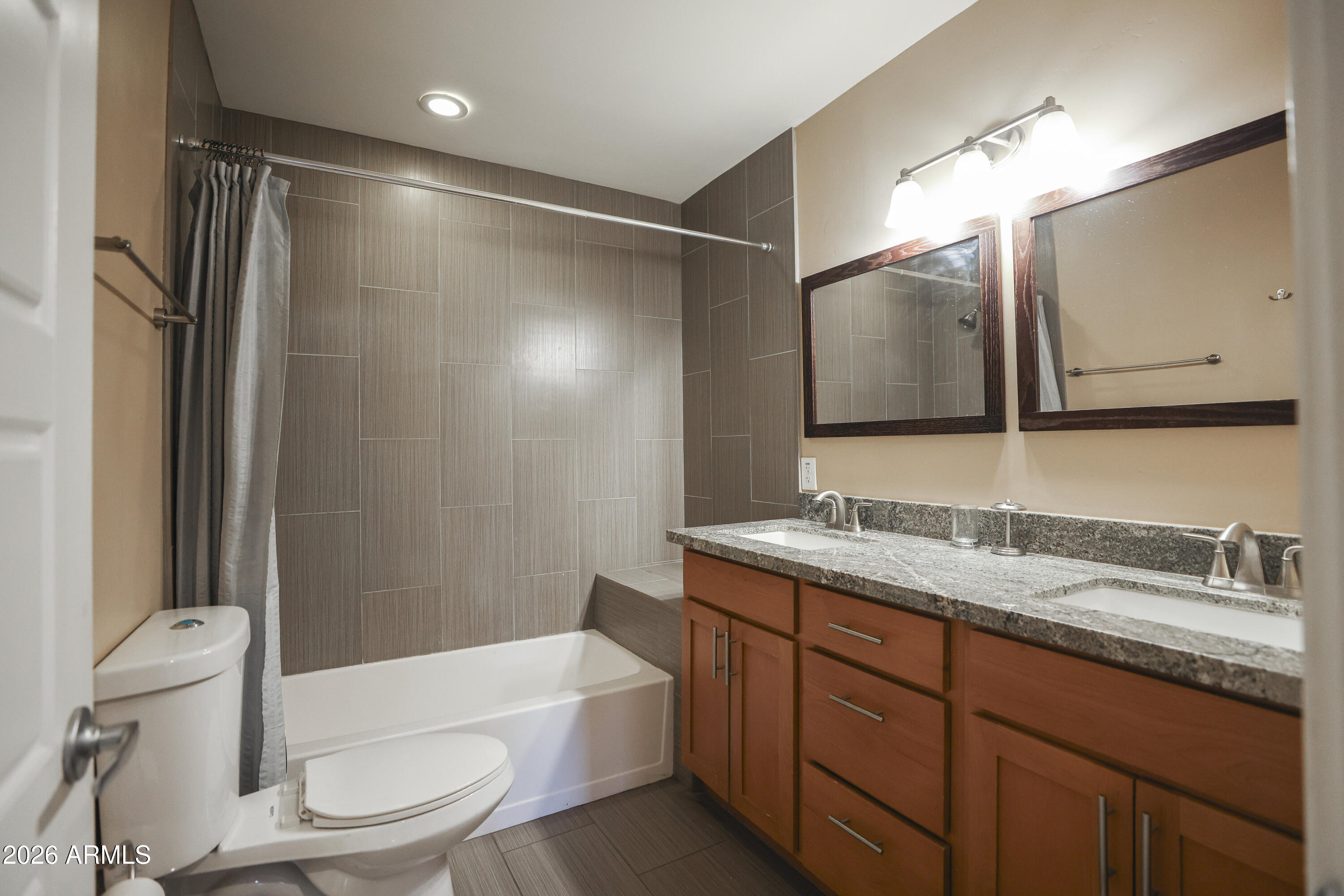 925 West McDowell Road, Unit 108 Phoenix, AZ 85007 - Photo 10 of 22 a bathroom with a granite countertop sink toilet and shower