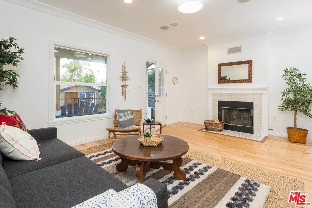 3421 Ferncroft Road Los Angeles, CA 90039 - Photo 12 of 35 a living room with furniture a fireplace and a table