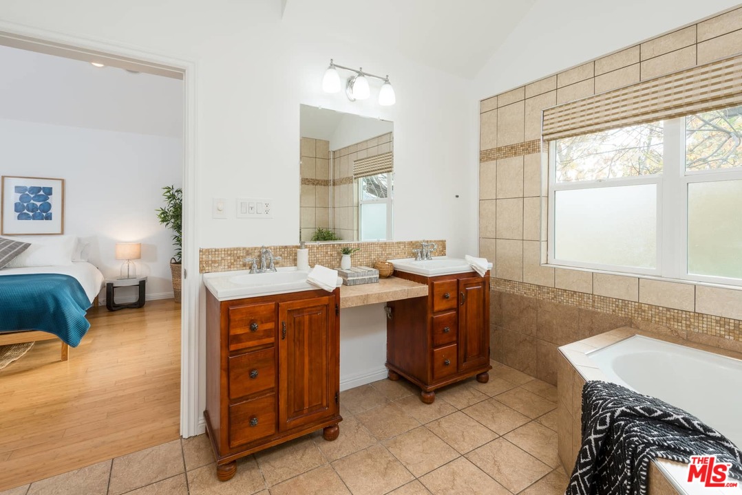 3421 Ferncroft Road Los Angeles, CA 90039 - Photo 19 of 35 a spacious bathroom with a double vanity sink and a mirror
