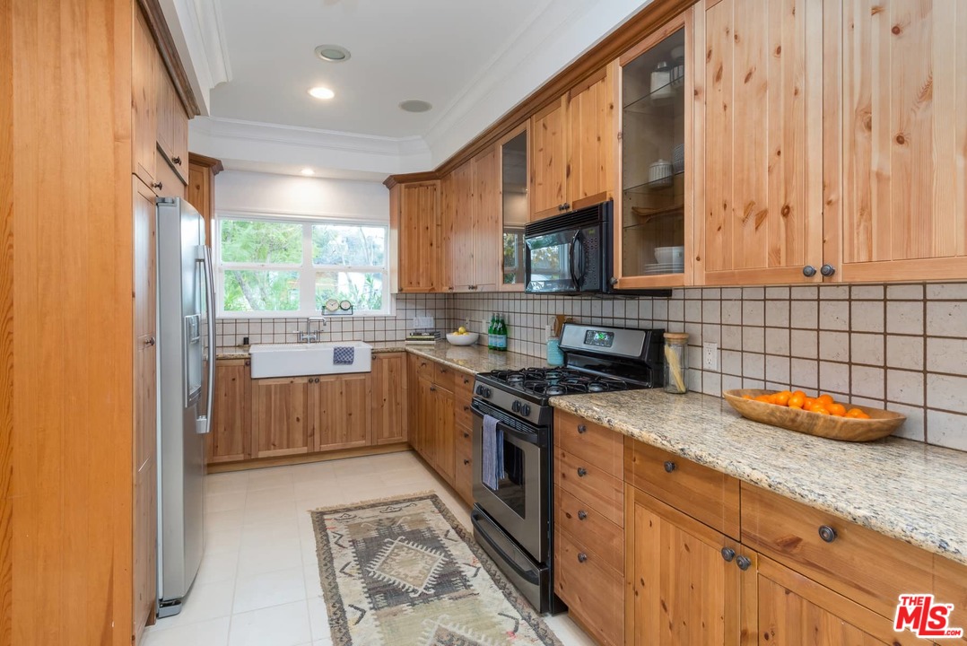 3421 Ferncroft Road Los Angeles, CA 90039 - Photo 8 of 35 a kitchen with stainless steel appliances granite countertop a stove a sink and a microwave