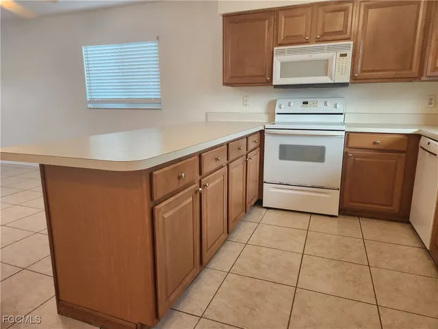 a kitchen with stainless steel appliances a sink stove and cabinets