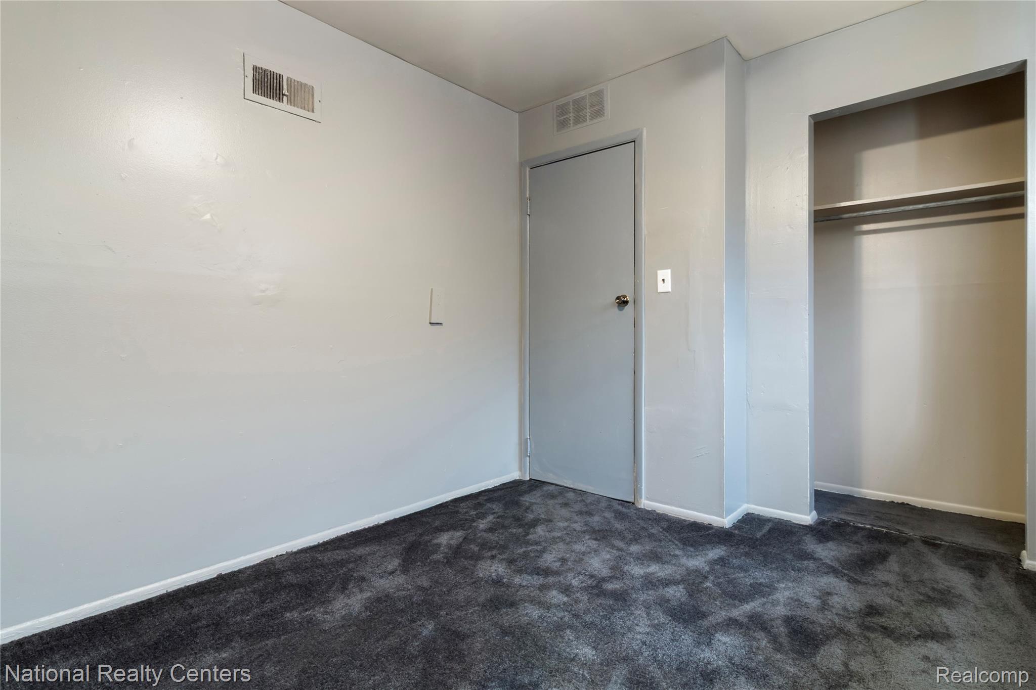 13525 Evergreen Road Detroit, MI 48223 - Photo 16 of 25 Unfurnished bedroom with dark carpet and a closet