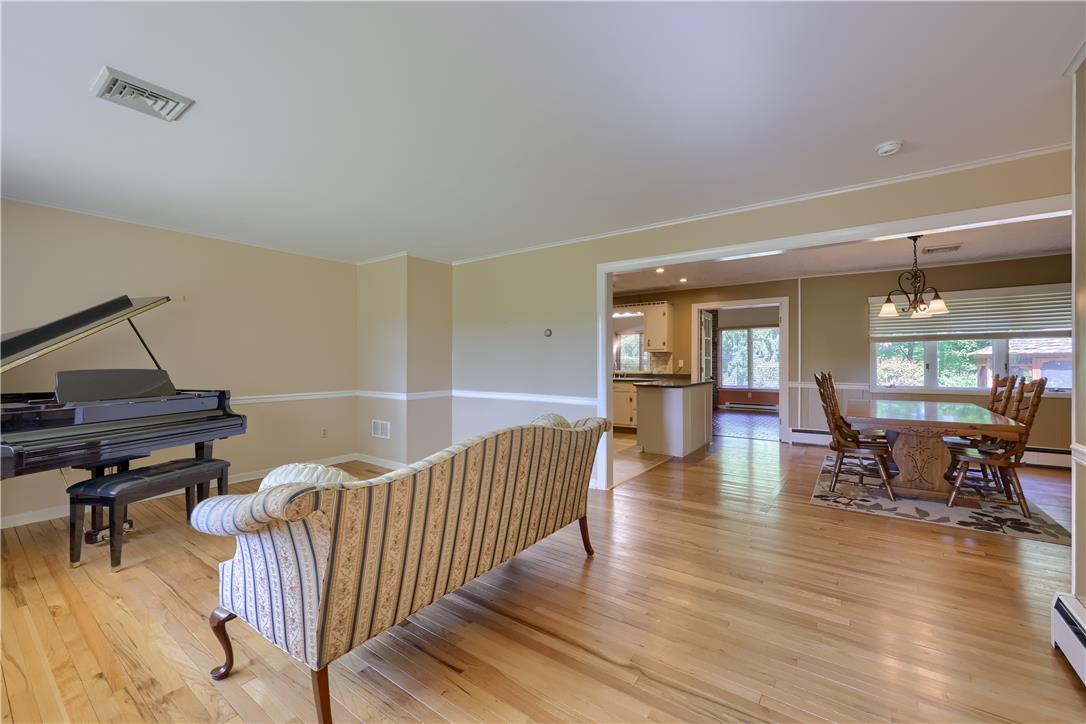 Coldsprings Rd Union Pottstown, PA 19465 - Photo 38 of 71 Blonde hardwood floors extend through an open-concept living and dining area, leading to a sun-drenched kitchen beyond.
