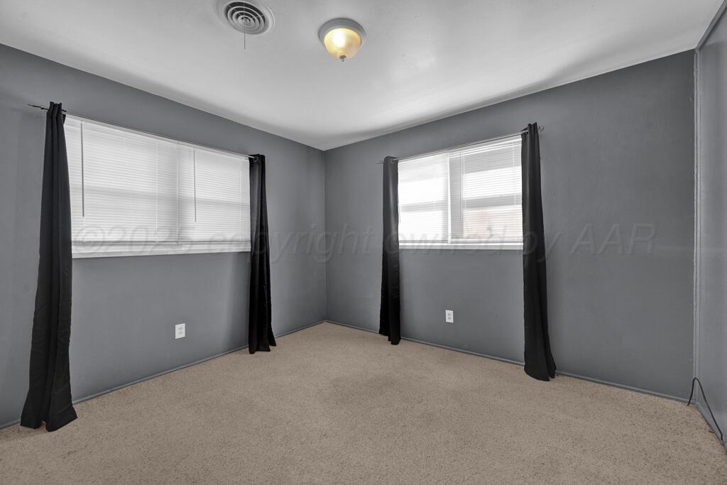 2909 South Marrs Street Amarillo, TX 79103 - Photo 11 of 21 a view of an empty room with window and wooden floor