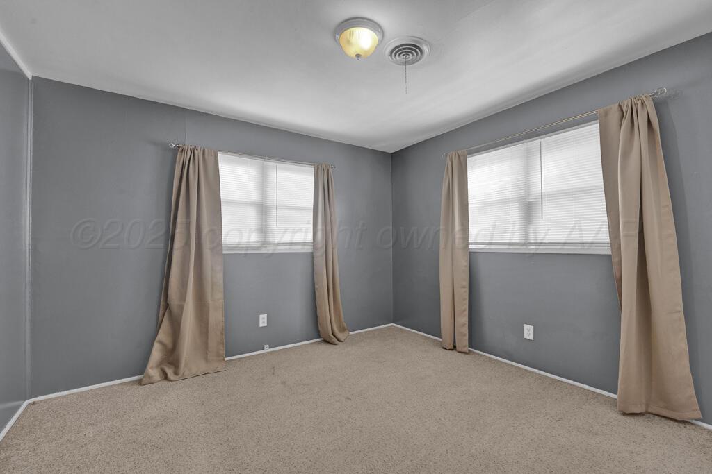2909 South Marrs Street Amarillo, TX 79103 - Photo 15 of 21 an empty room with windows and closet
