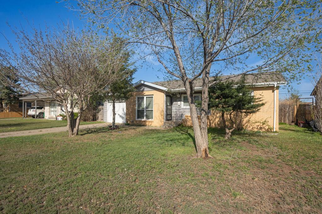 2909 South Marrs Street Amarillo, TX 79103 - Photo 2 of 21 a view of a house with backyard and trees