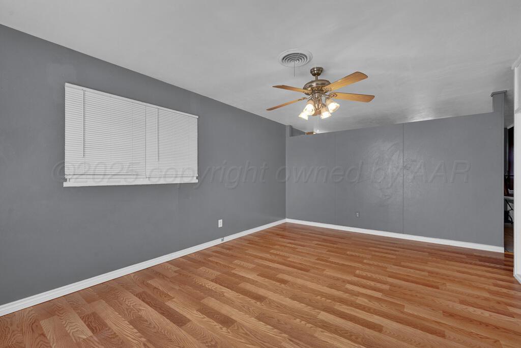 2909 South Marrs Street Amarillo, TX 79103 - Photo 5 of 21 a view of an empty room with window and a chandelier fan