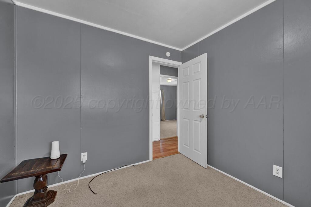 2909 South Marrs Street Amarillo, TX 79103 - Photo 10 of 21 a view of a livingroom with a chair and wooden floor
