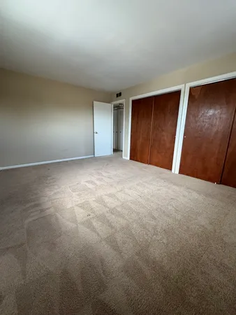 a view of an empty room and wooden floor