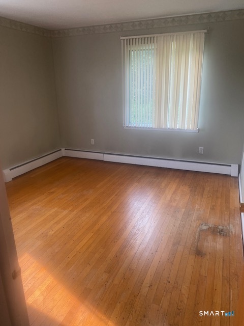 107 Tower Road Brookfield, CT 06804 - Photo 9 of 19 an empty room with wooden floor and windows