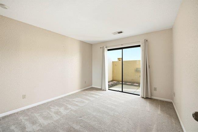 1067 Padre Drive, Unit 2 Salinas, CA 93901 - Photo 15 of 24 an empty room with sliding glass door