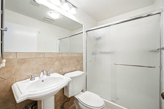 1067 Padre Drive, Unit 2 Salinas, CA 93901 - Photo 17 of 24 a bathroom with a sink a toilet and shower