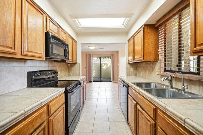 1067 Padre Drive, Unit 2 Salinas, CA 93901 - Photo 10 of 24 a kitchen with stainless steel appliances granite countertop a sink and a stove