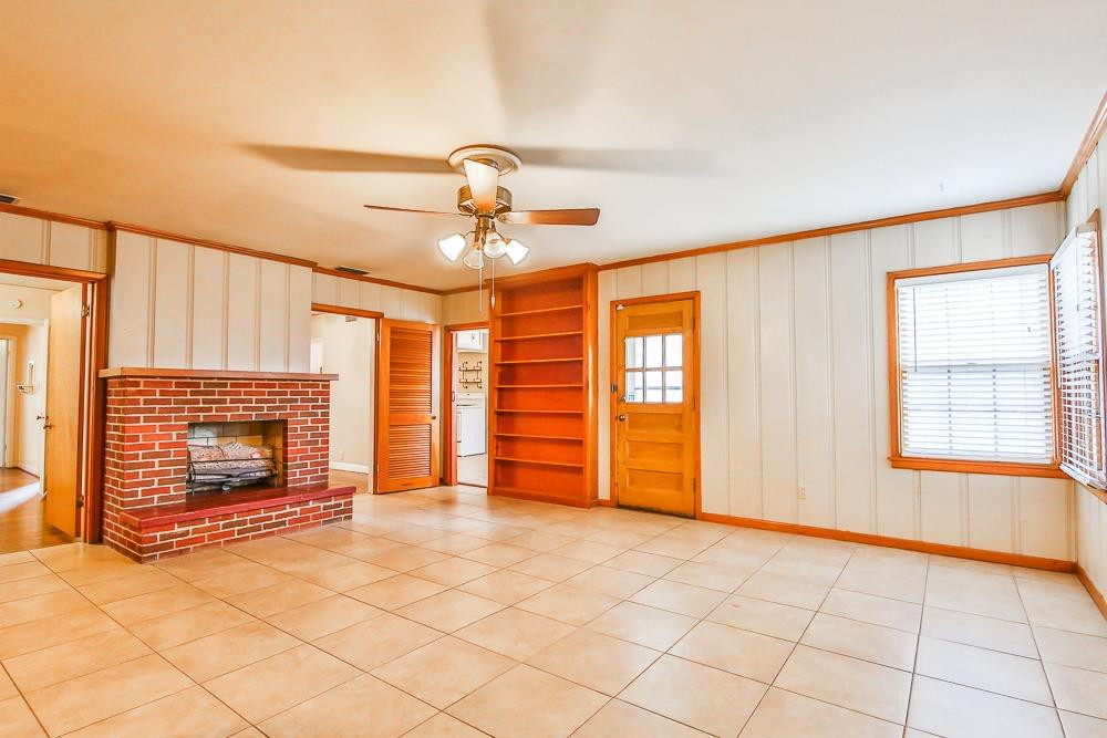 2318 29th Street Lubbock, TX 79411 - Photo 15 of 32 a view of an empty room with a fireplace and a window