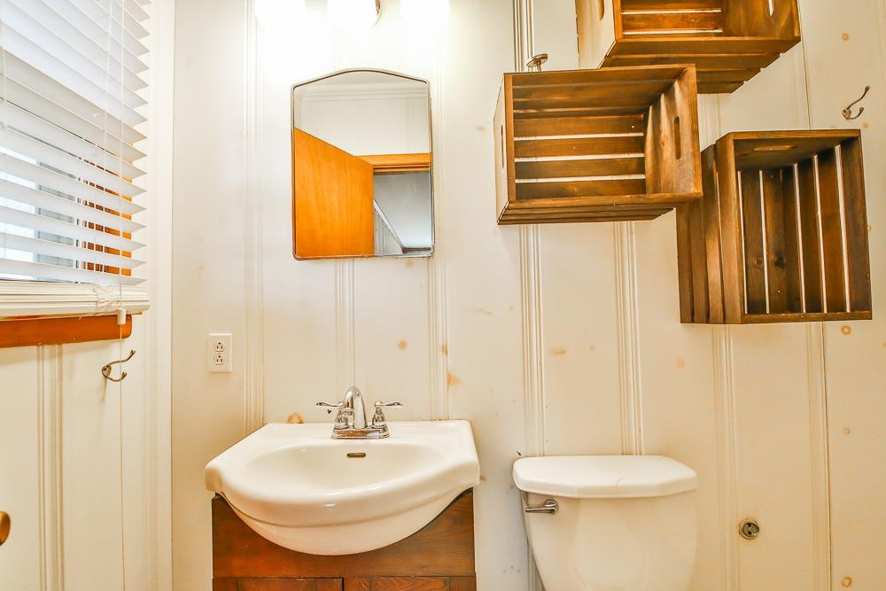 2318 29th Street Lubbock, TX 79411 - Photo 17 of 32 a bathroom with a sink and a mirror