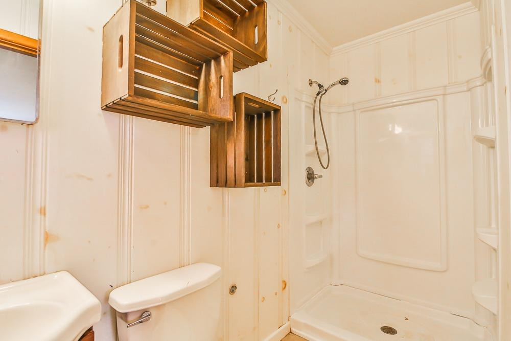 2318 29th Street Lubbock, TX 79411 - Photo 18 of 32 a bathroom with a shower a toilet and a sink
