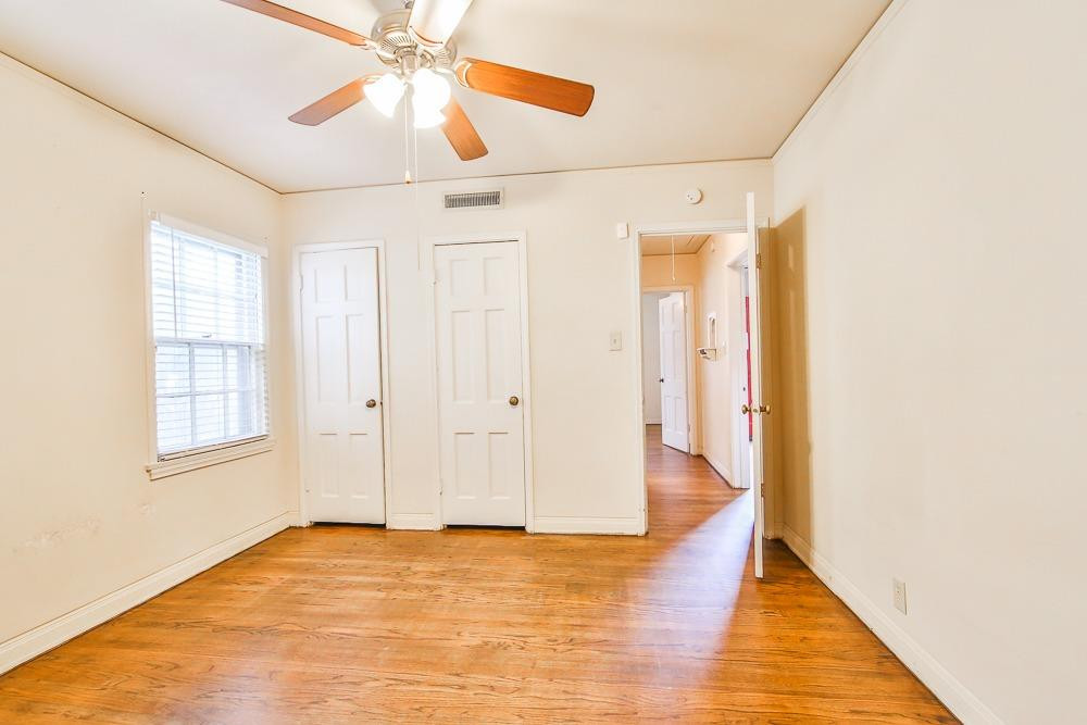2318 29th Street Lubbock, TX 79411 - Photo 20 of 32 a view of an empty room with window and wooden floor