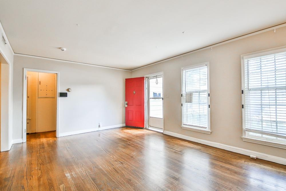 2318 29th Street Lubbock, TX 79411 - Photo 5 of 32 an empty room with wooden floor and windows