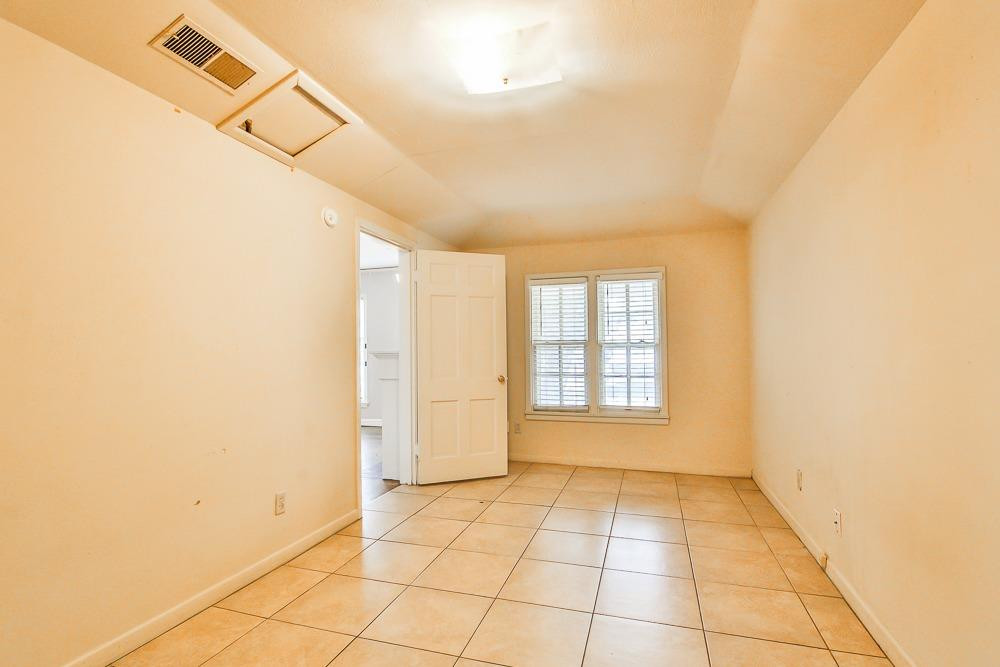 2318 29th Street Lubbock, TX 79411 - Photo 7 of 32 a view of an empty room with a window